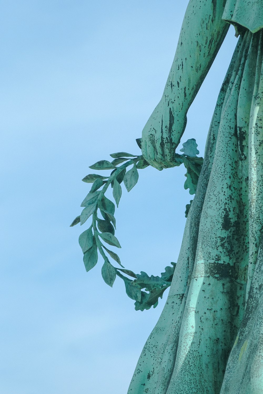 a close up of a statue of a woman with a wreath around her neck