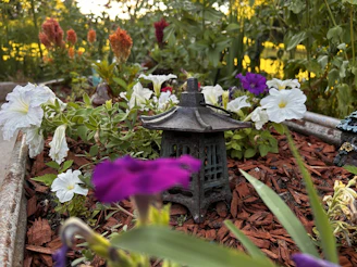 A vibrant garden corner with colorful flowers and a hanging lantern capturing golden hour glow.