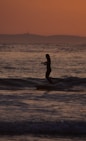 a person riding a surfboard on a wave in the ocean