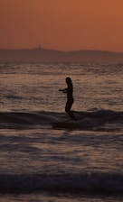 a person riding a surfboard on a wave in the ocean