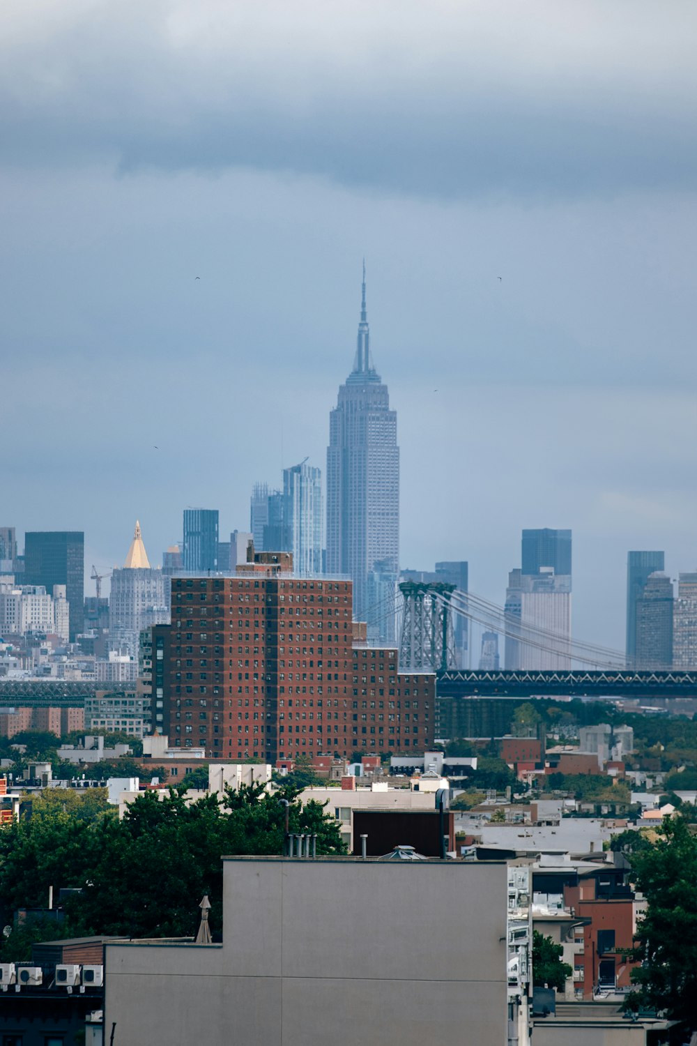 a city skyline with a bridge in the background