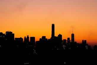 City skyline with business district buildings at sunset, symbolizing growth and opportunity.