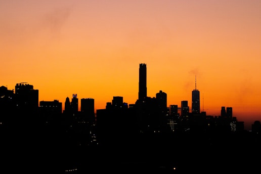 City skyline with business district buildings at sunset, symbolizing growth and opportunity.