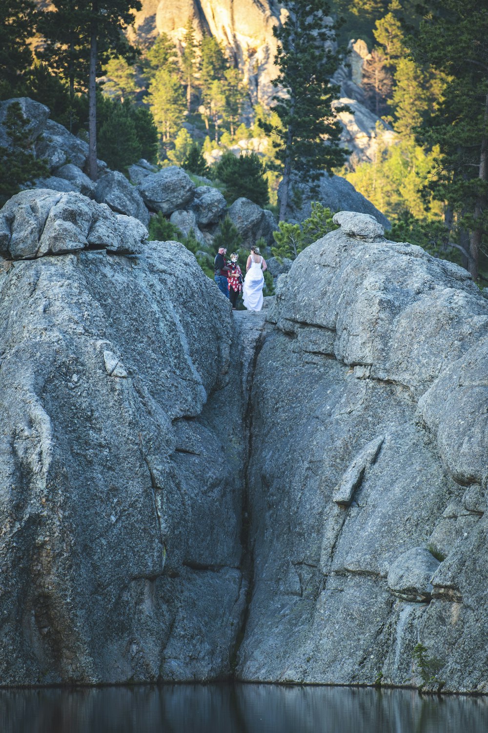 a couple of people that are standing on some rocks