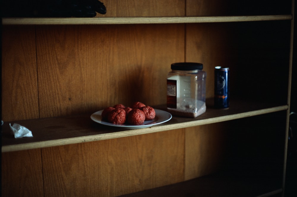 a plate of cookies on a wooden shelf