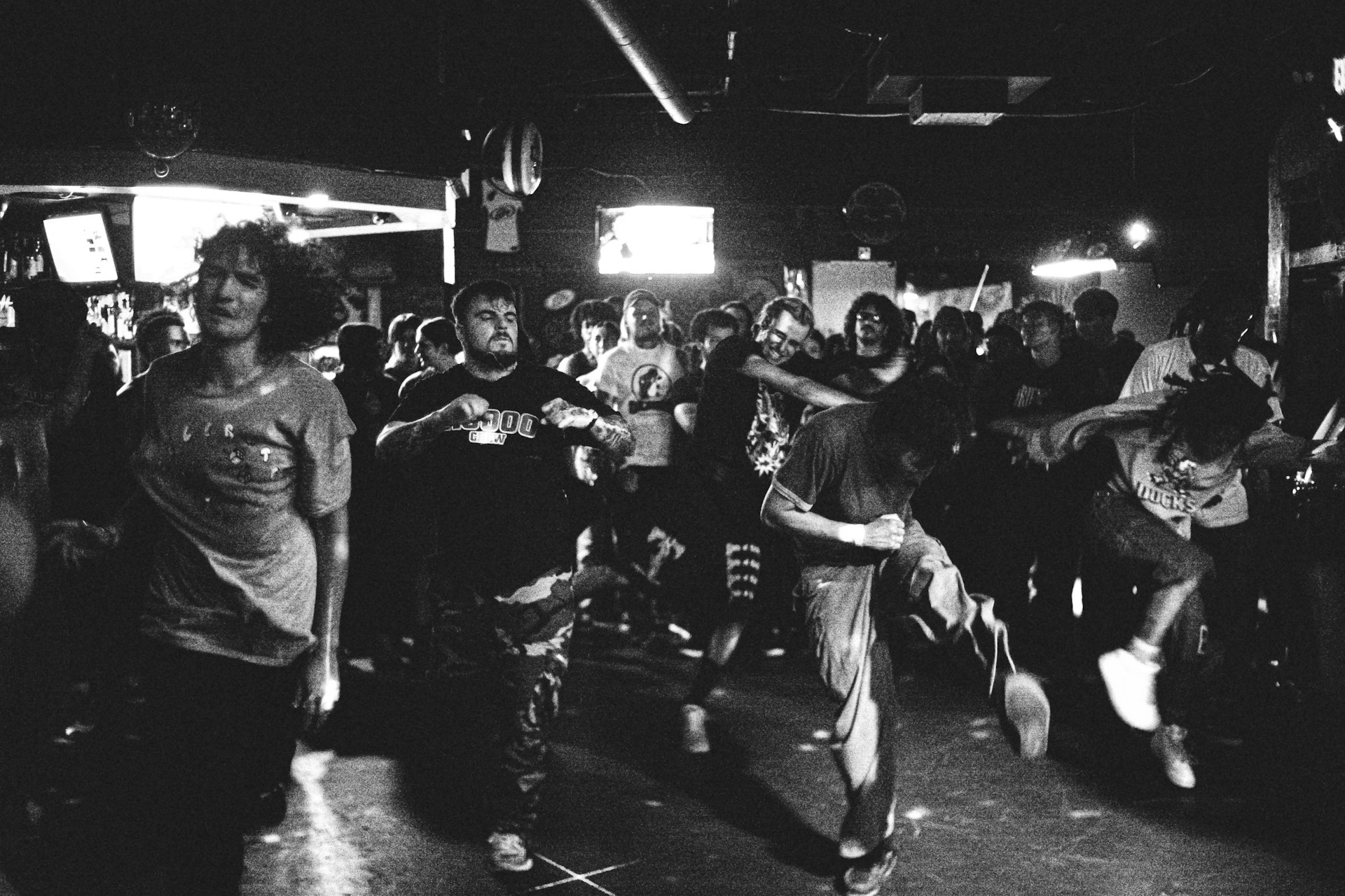 a black and white photo of a group of people dancing