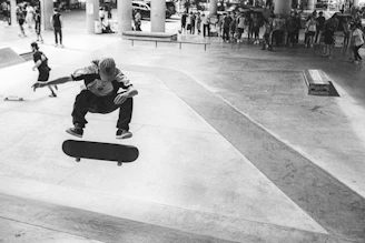 A group of diverse skaters mid-trick on a concrete plaza, embodying the raw energy of og dogtown culture.