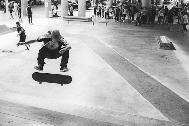 A group of diverse skaters mid-trick on a concrete plaza, embodying the raw energy of og dogtown culture.