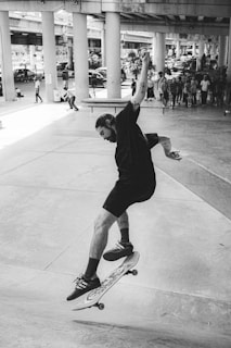 A dynamic skateboarder performing a trick in an urban skate park.