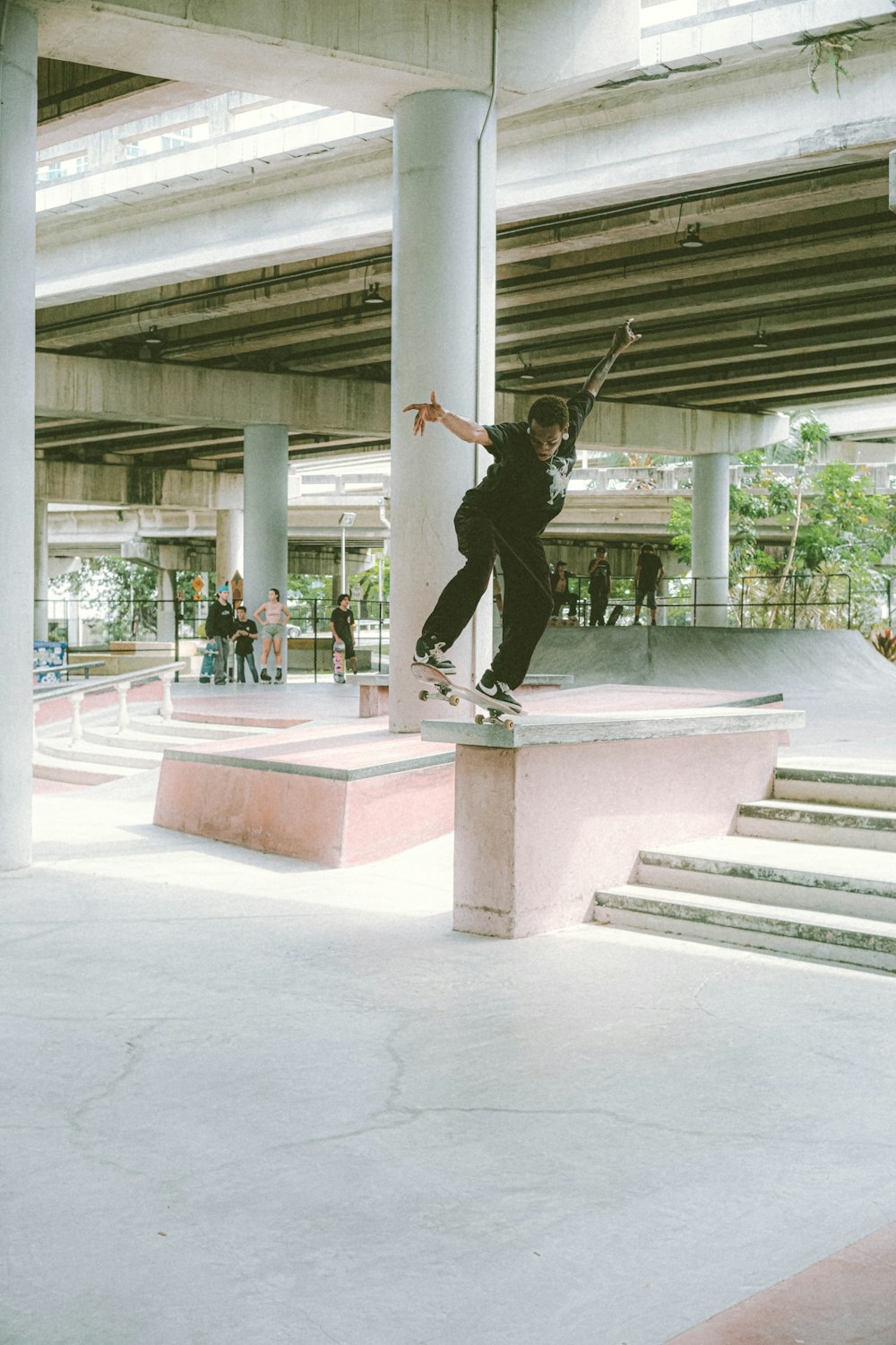 a man riding a skateboard up the side of a cement ramp