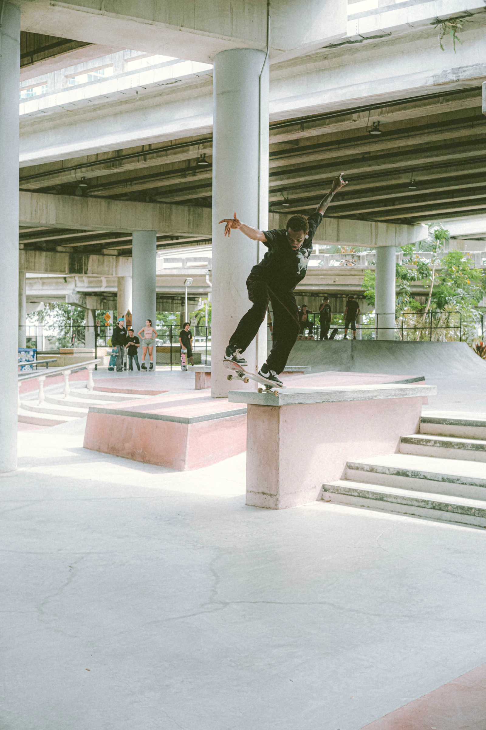 Skateboarder grinding a concrete ledge at an urban skatepark