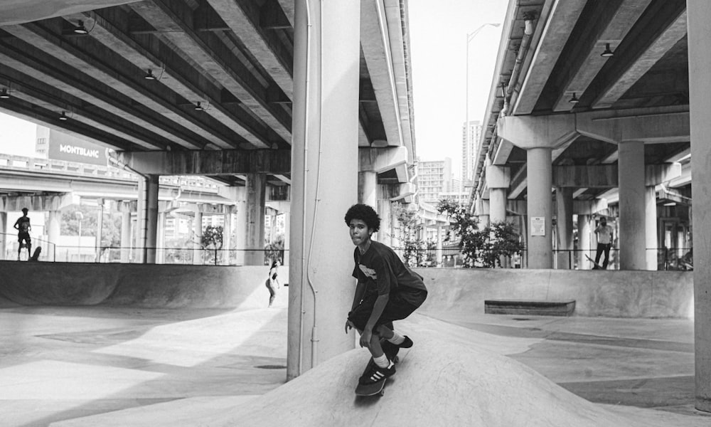 a young man riding a skateboard down a ramp