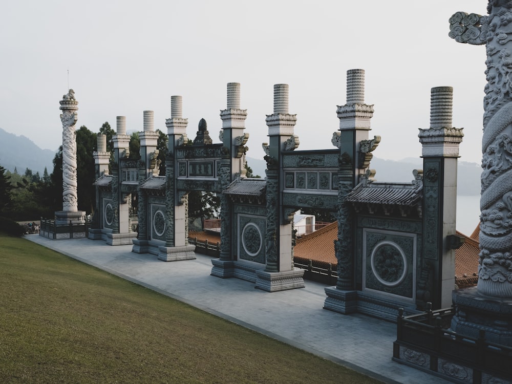 a group of statues sitting on top of a lush green field