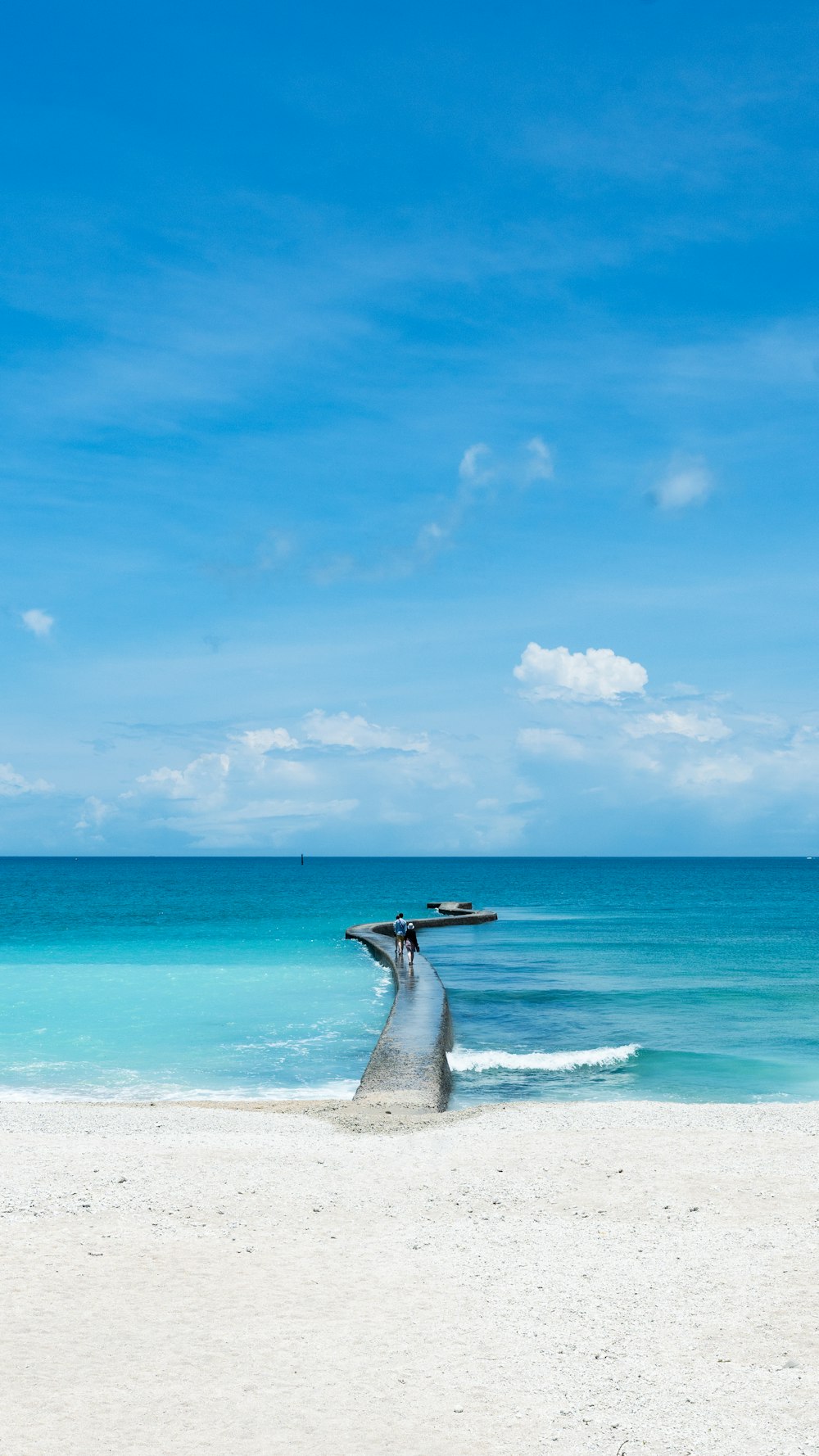 a boat sitting on top of a wooden post on a beach