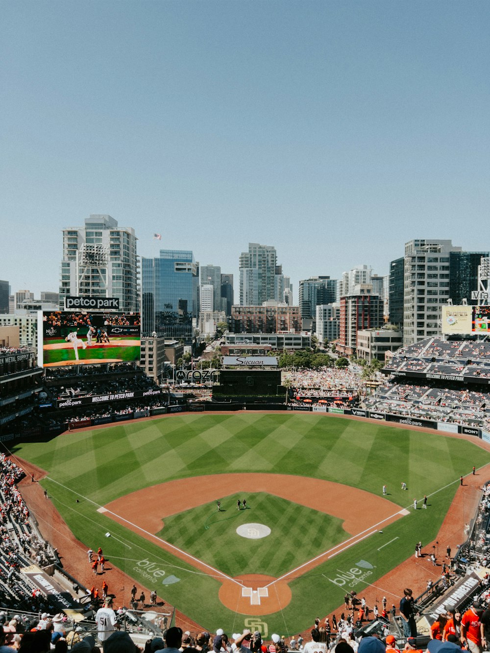 a view of a baseball field with a city in the background