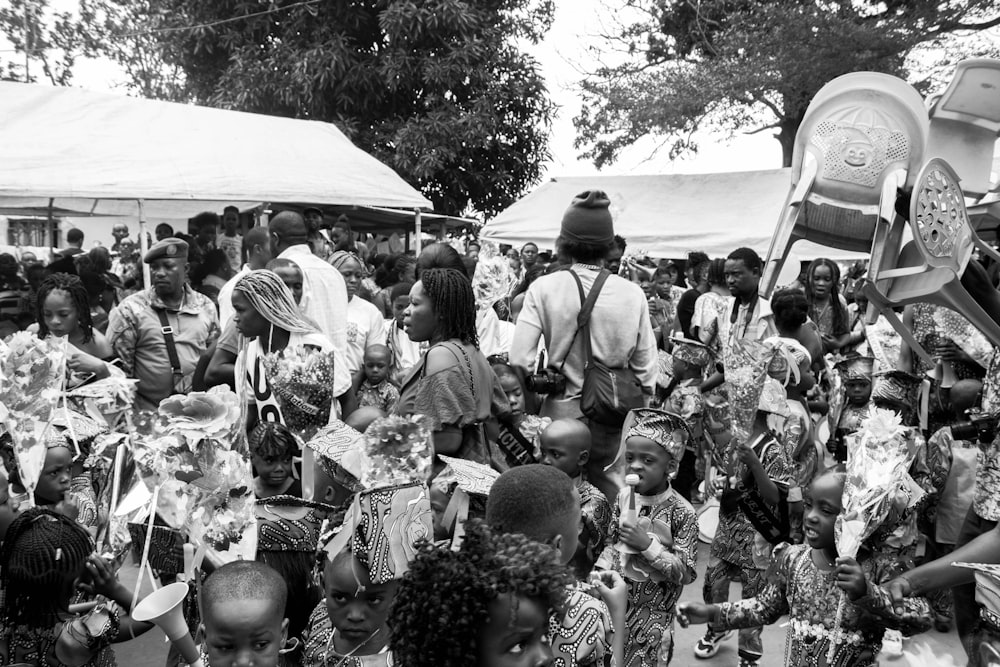 a crowd of people standing around each other