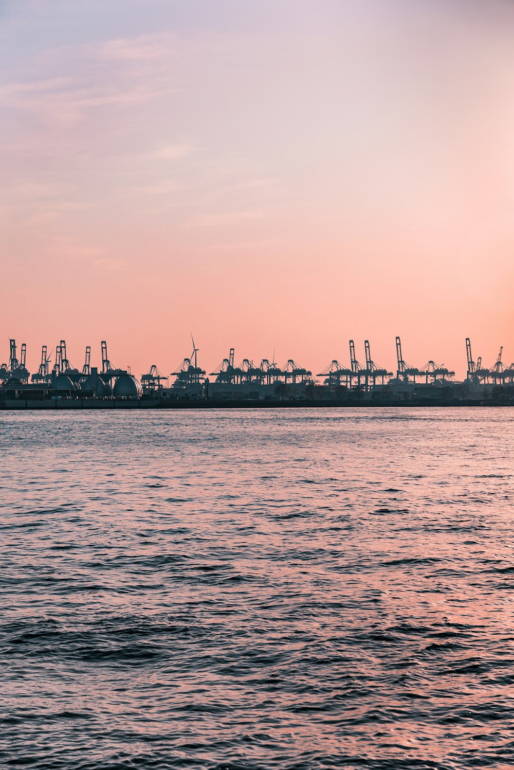 a large body of water with a bunch of ships in the distance