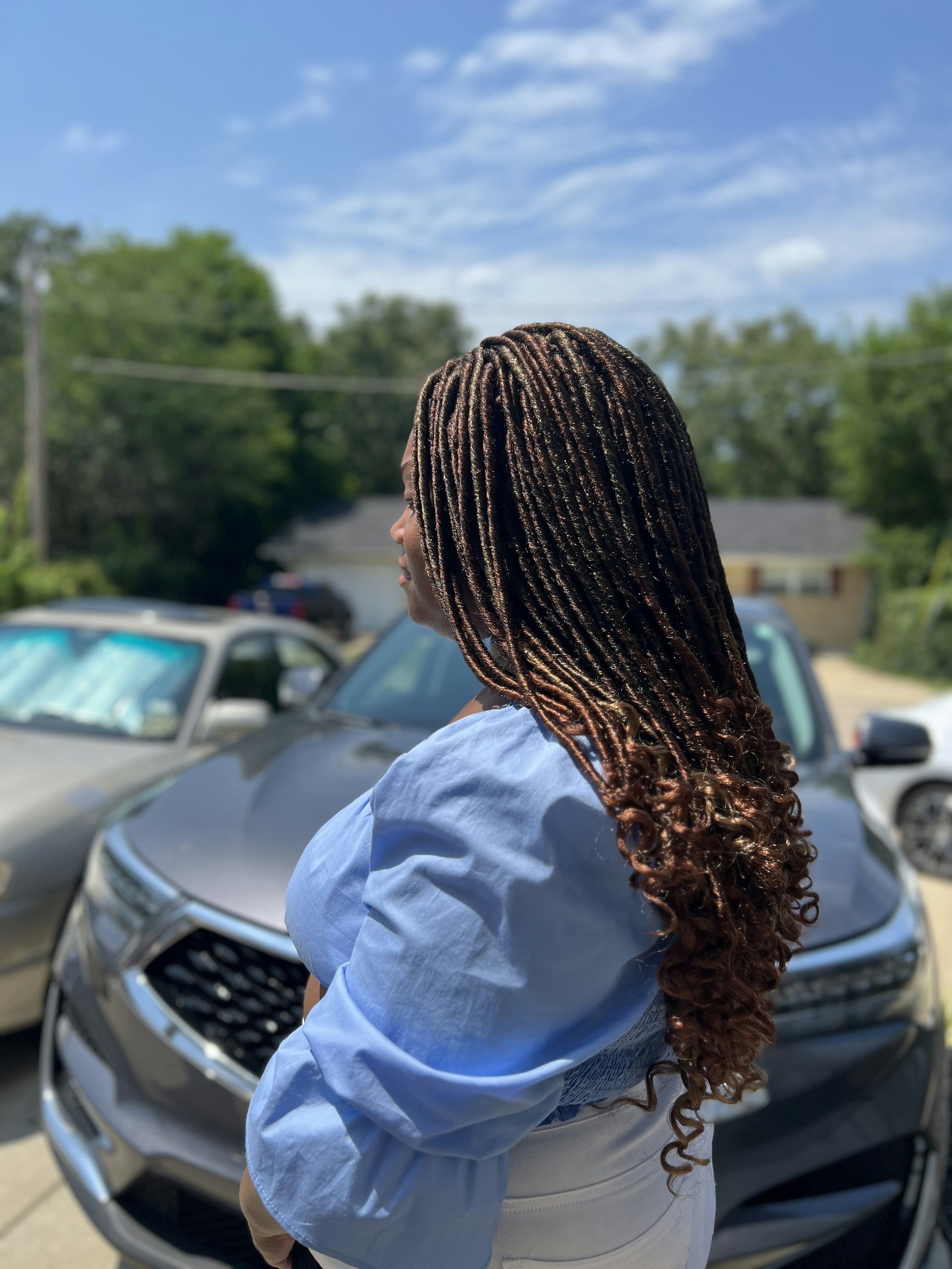 Amara Touré with loc hairstyle and creative professional look
