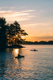 a couple of people in a boat on a lake