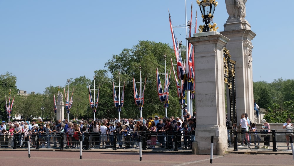 a crowd of people standing in front of a statue