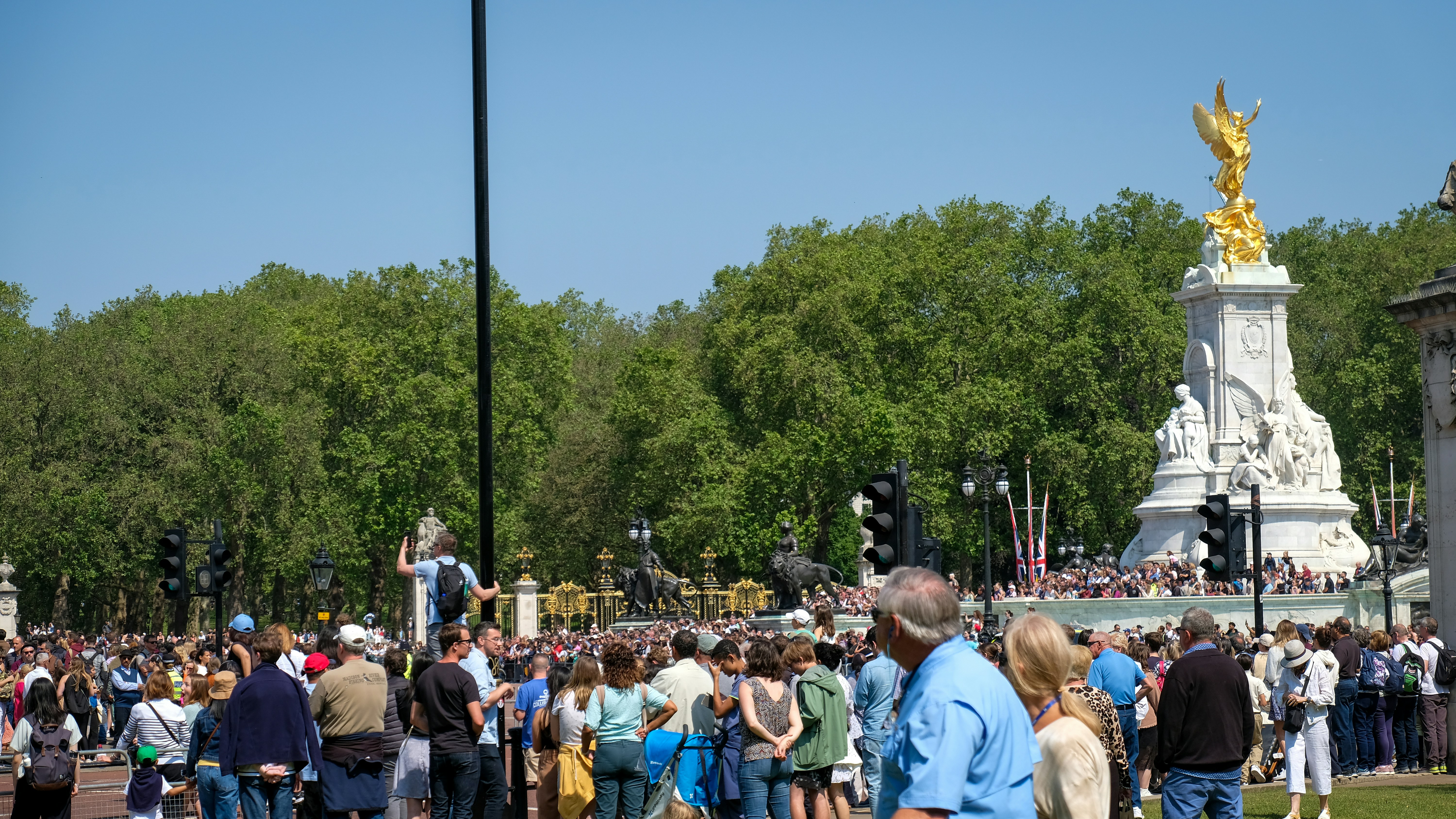 A political rally scene, with a speaker at the podium and a crowd listening intently, representing future political moves and public reception.