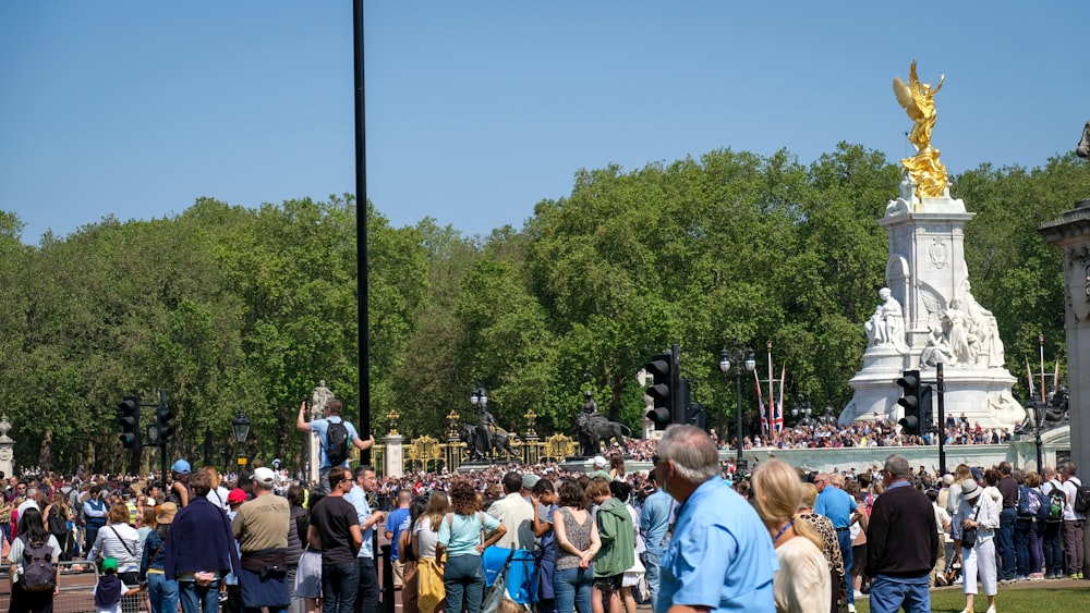 a large group of people standing in a park