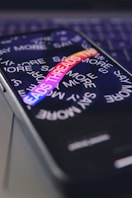 a close up of a cell phone on a laptop