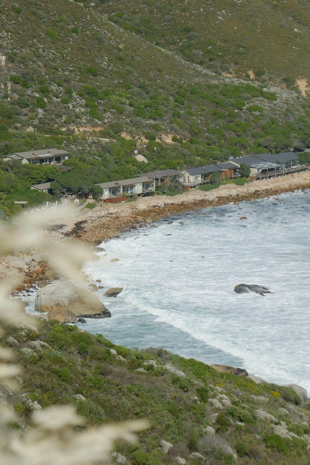 a view of a beach with houses and a body of water