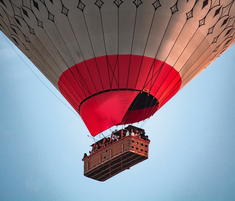 a large hot air balloon flying through a blue sky