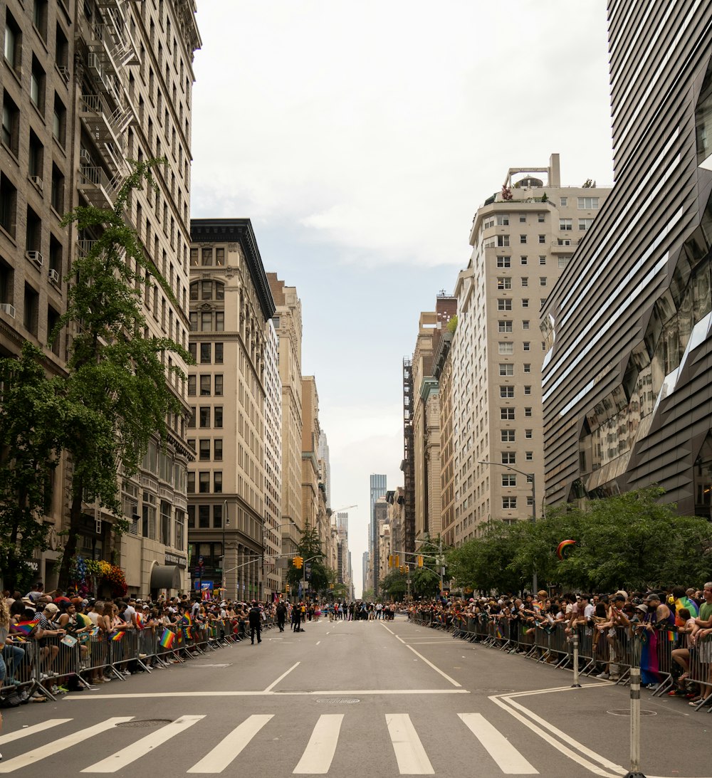 a crowd of people standing on the side of a road