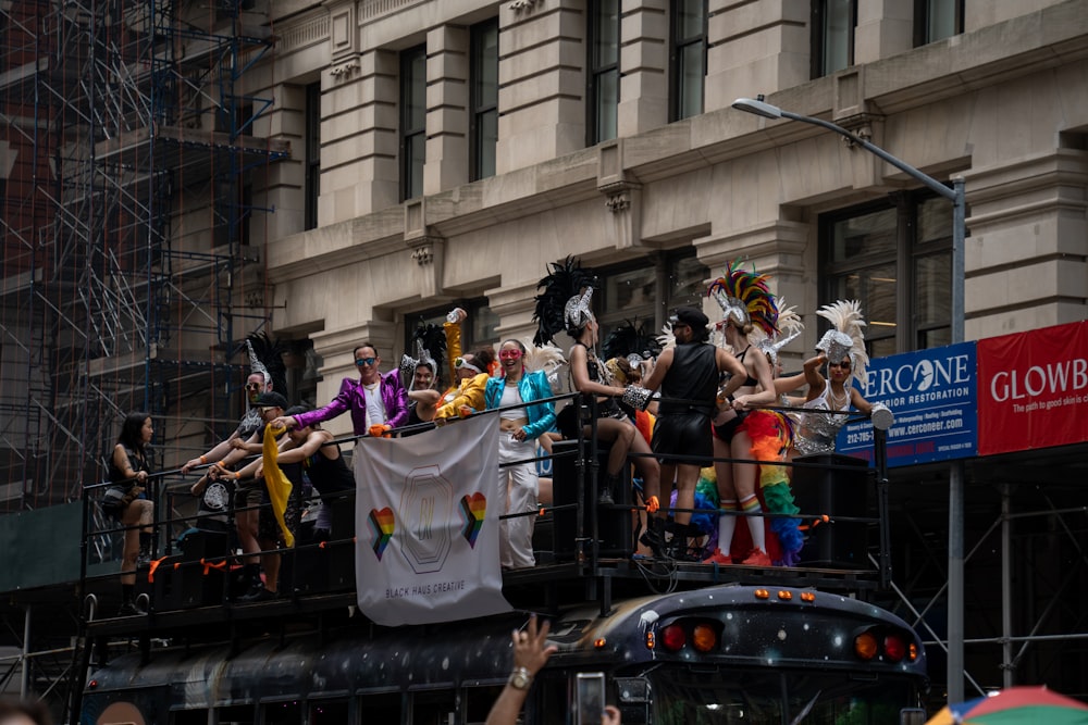 a group of people standing on top of a truck