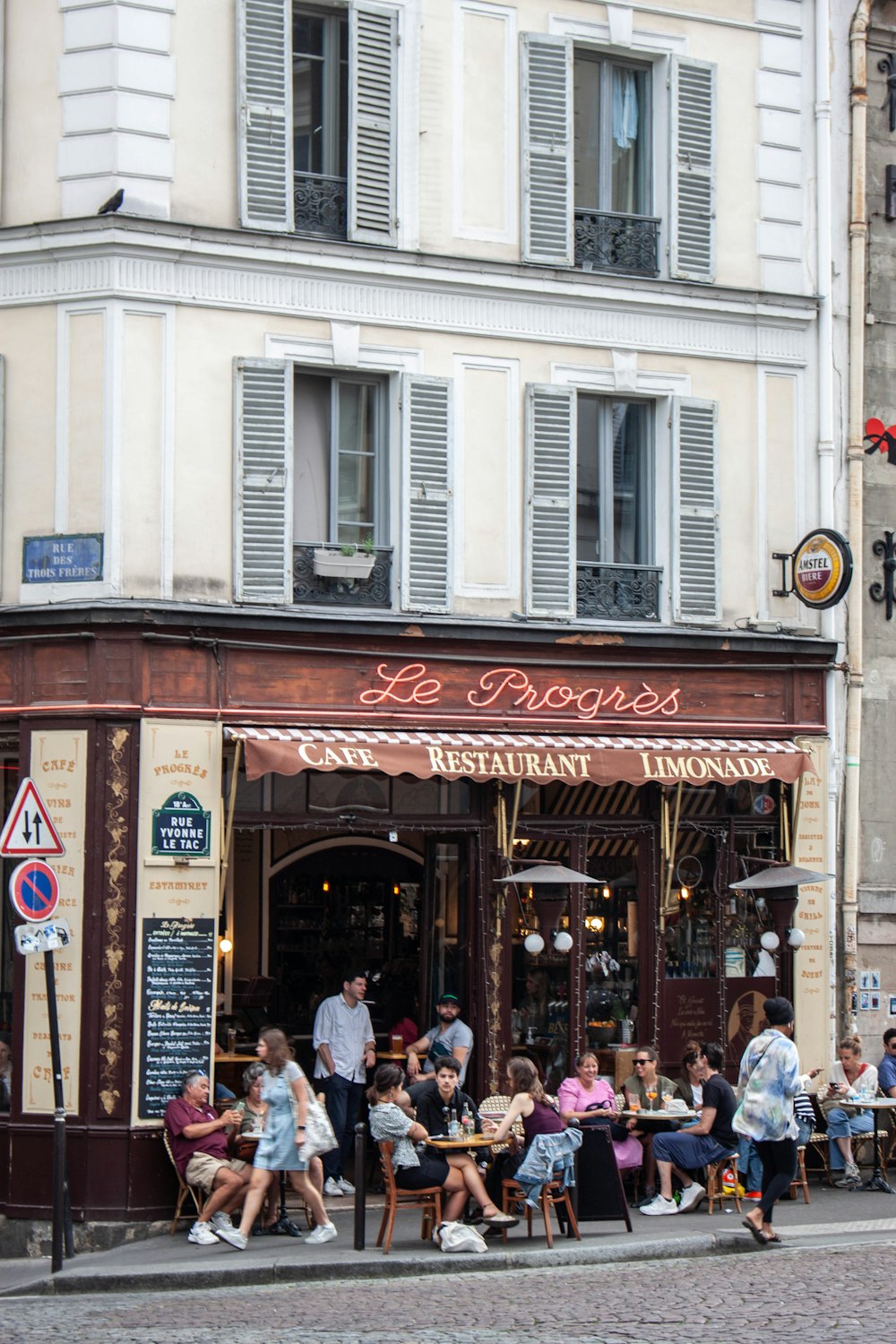 a group of people sitting outside of a restaurant