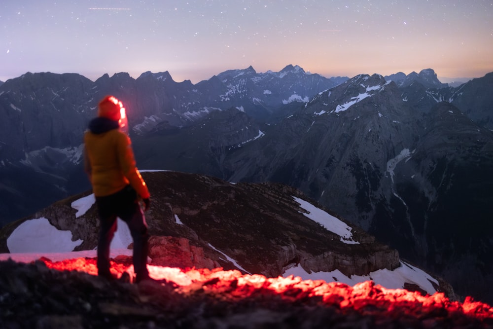 a person standing on top of a snow covered mountain