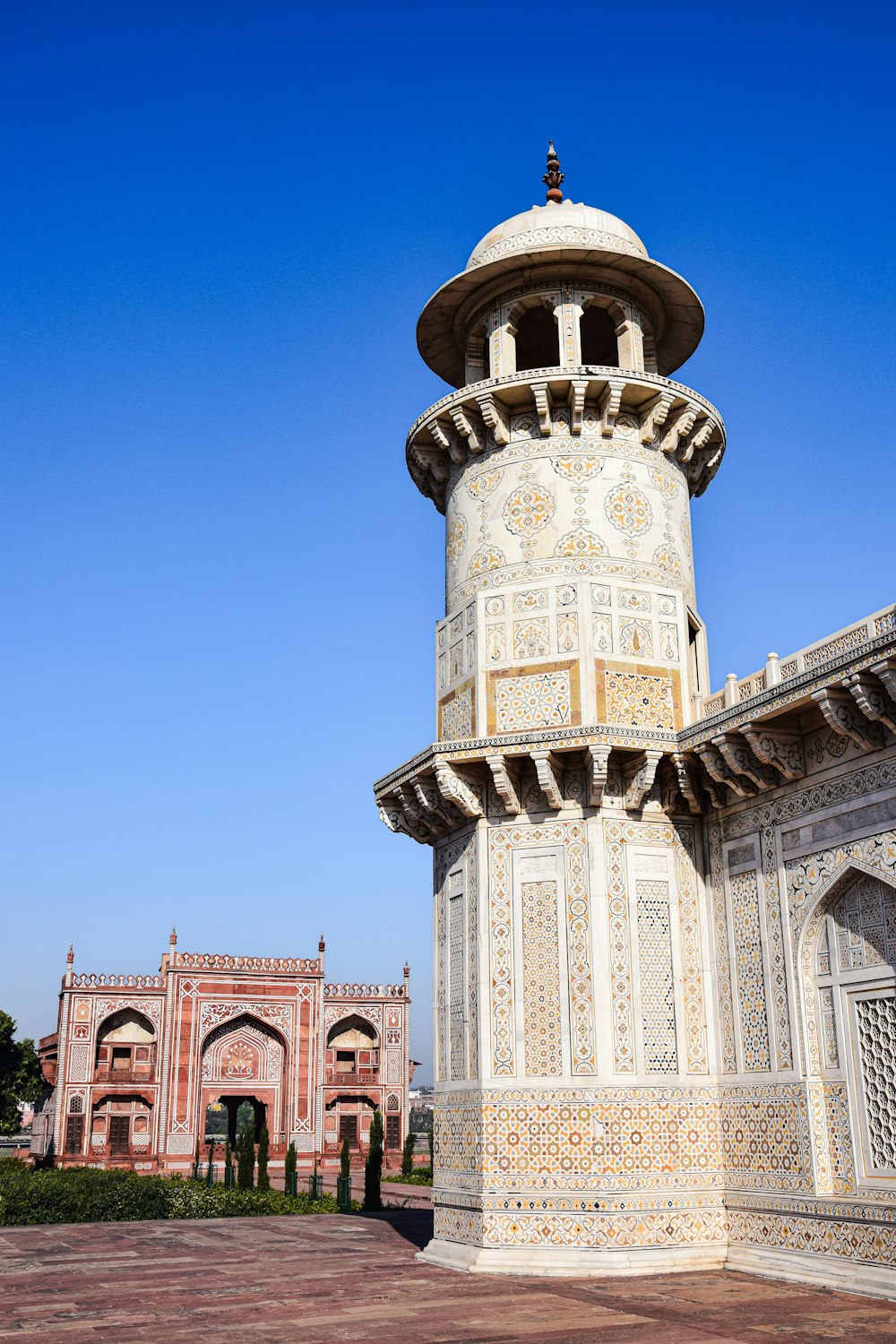 a tall white tower sitting next to a building