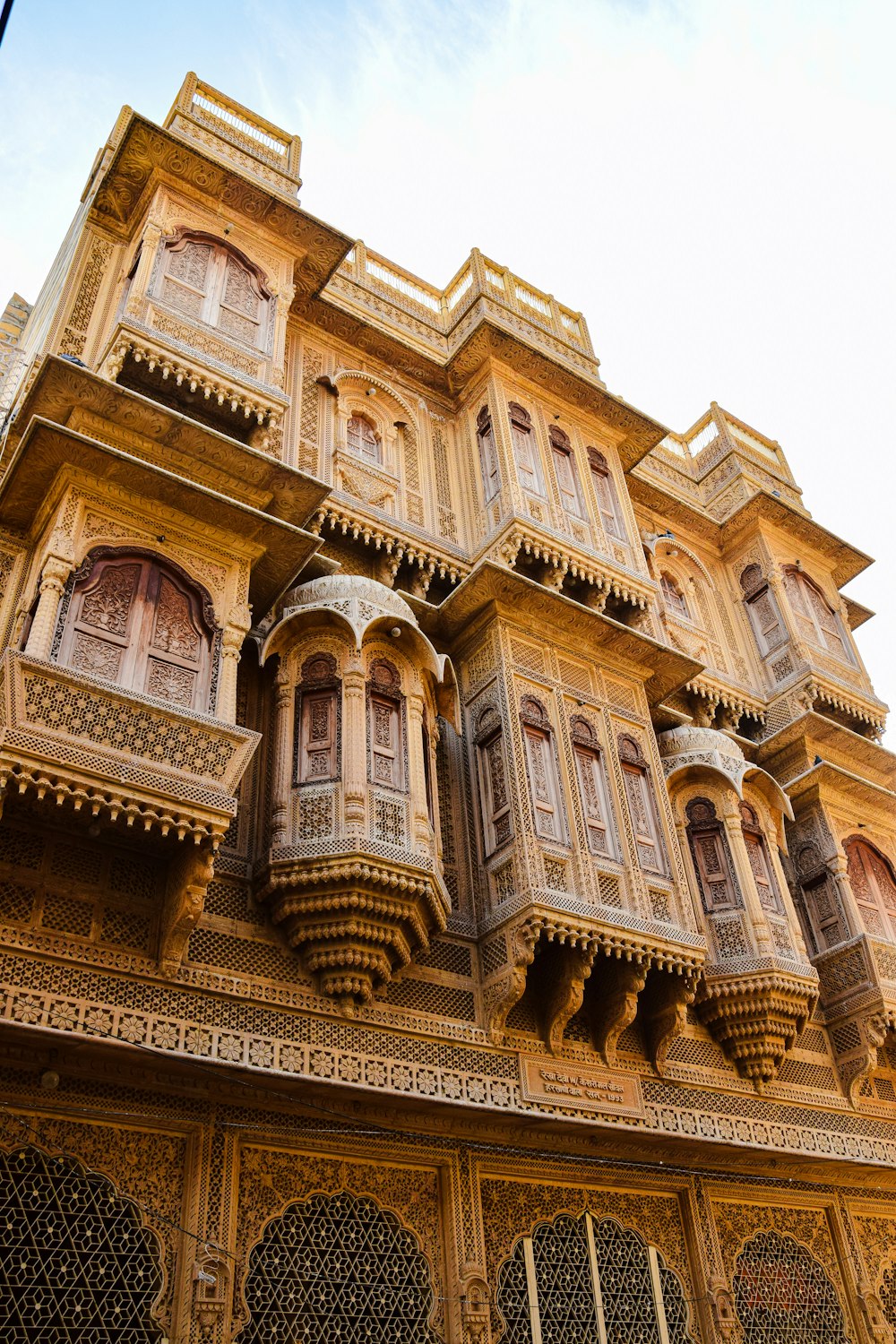 a tall building with many windows and balconies