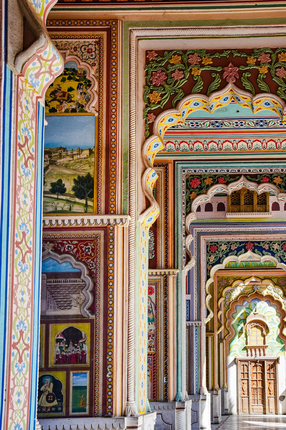 a colorfully painted building with columns and arches