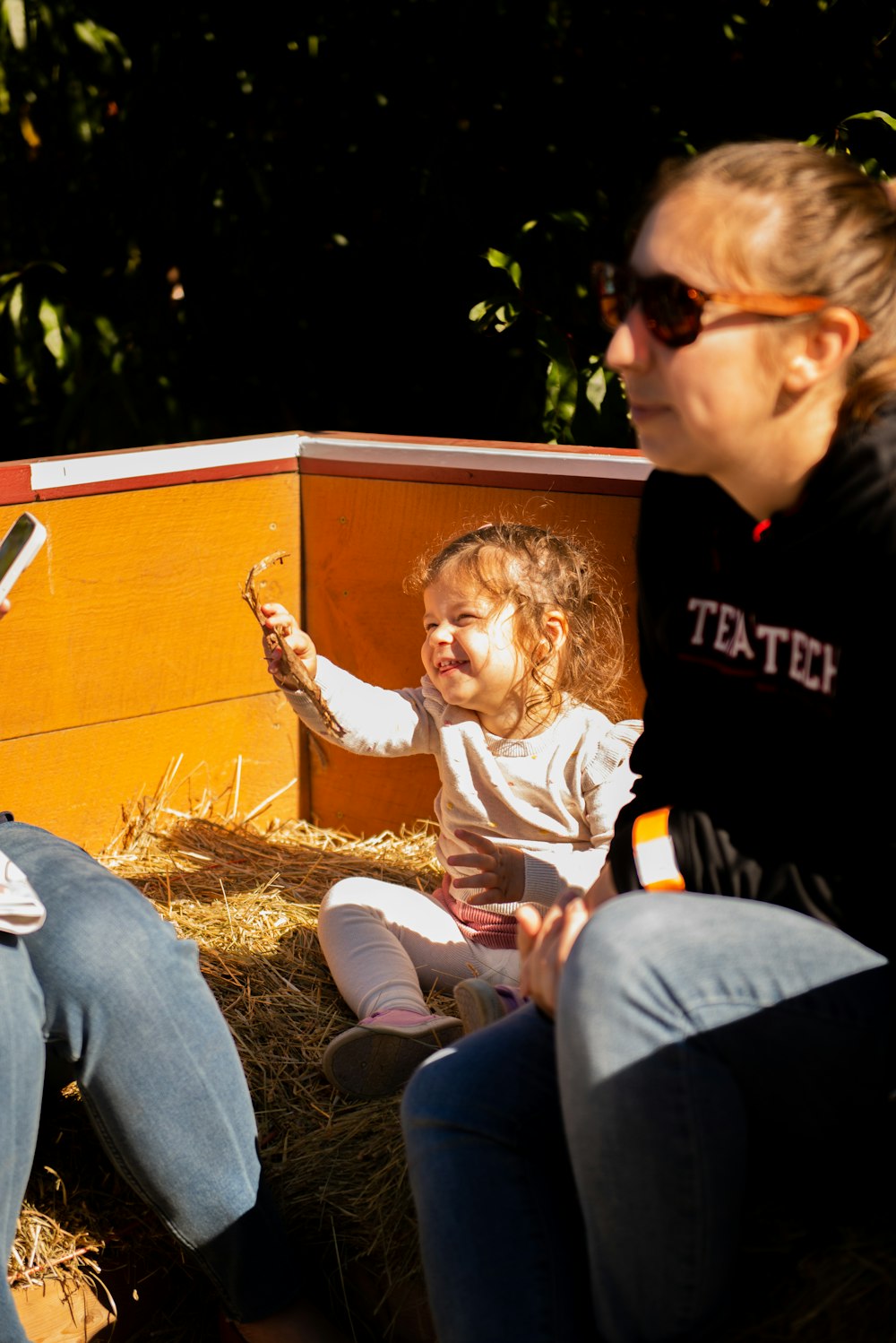 a woman sitting next to a little girl