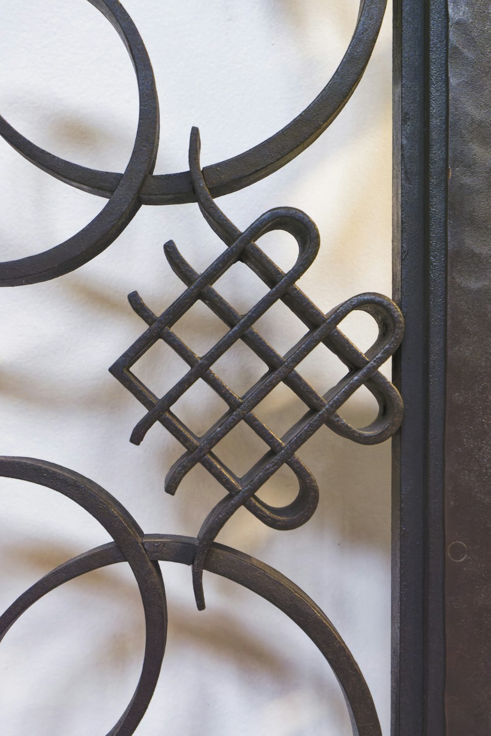 a close up of a metal gate with a design on it