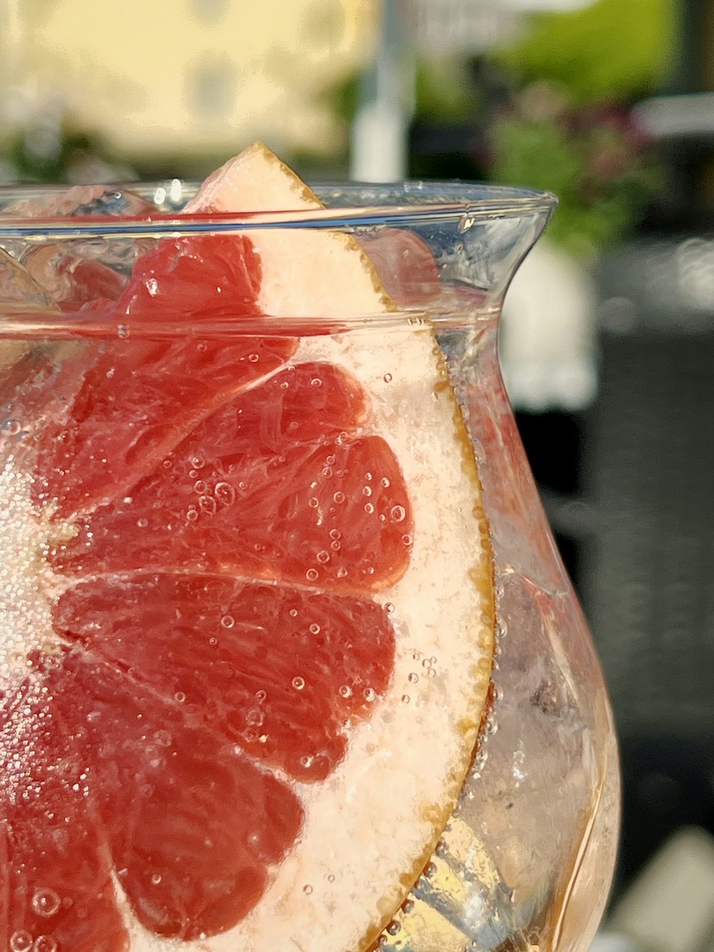 a close up of a grapefruit in a pitcher of water