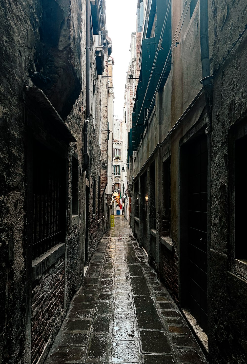 a narrow alley way with people walking down it