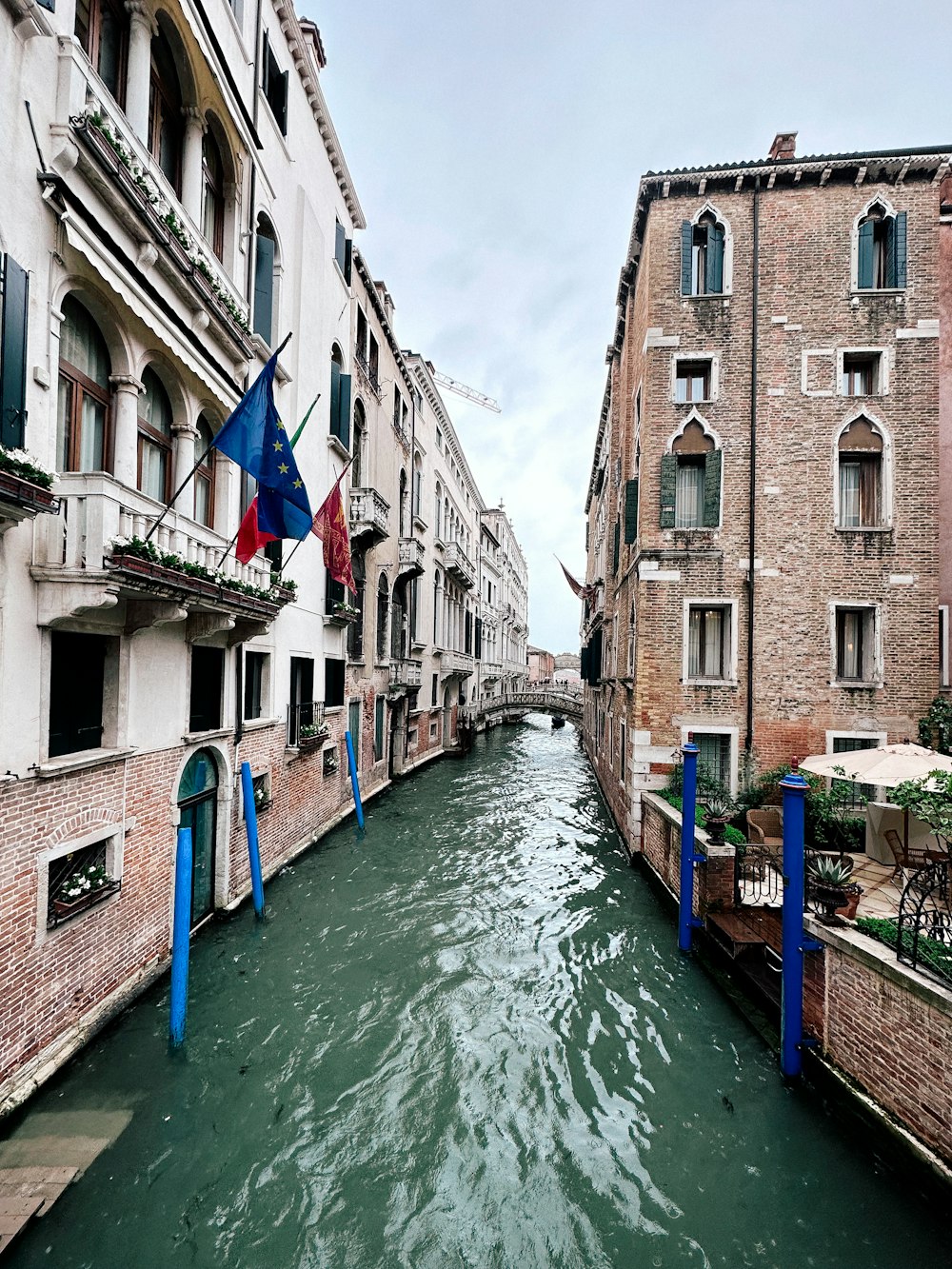 a narrow canal in a city with buildings on both sides