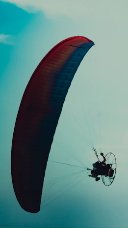 Close-up of a pilot preparing paramotor equipment, embodying dedication and passion for the mission.