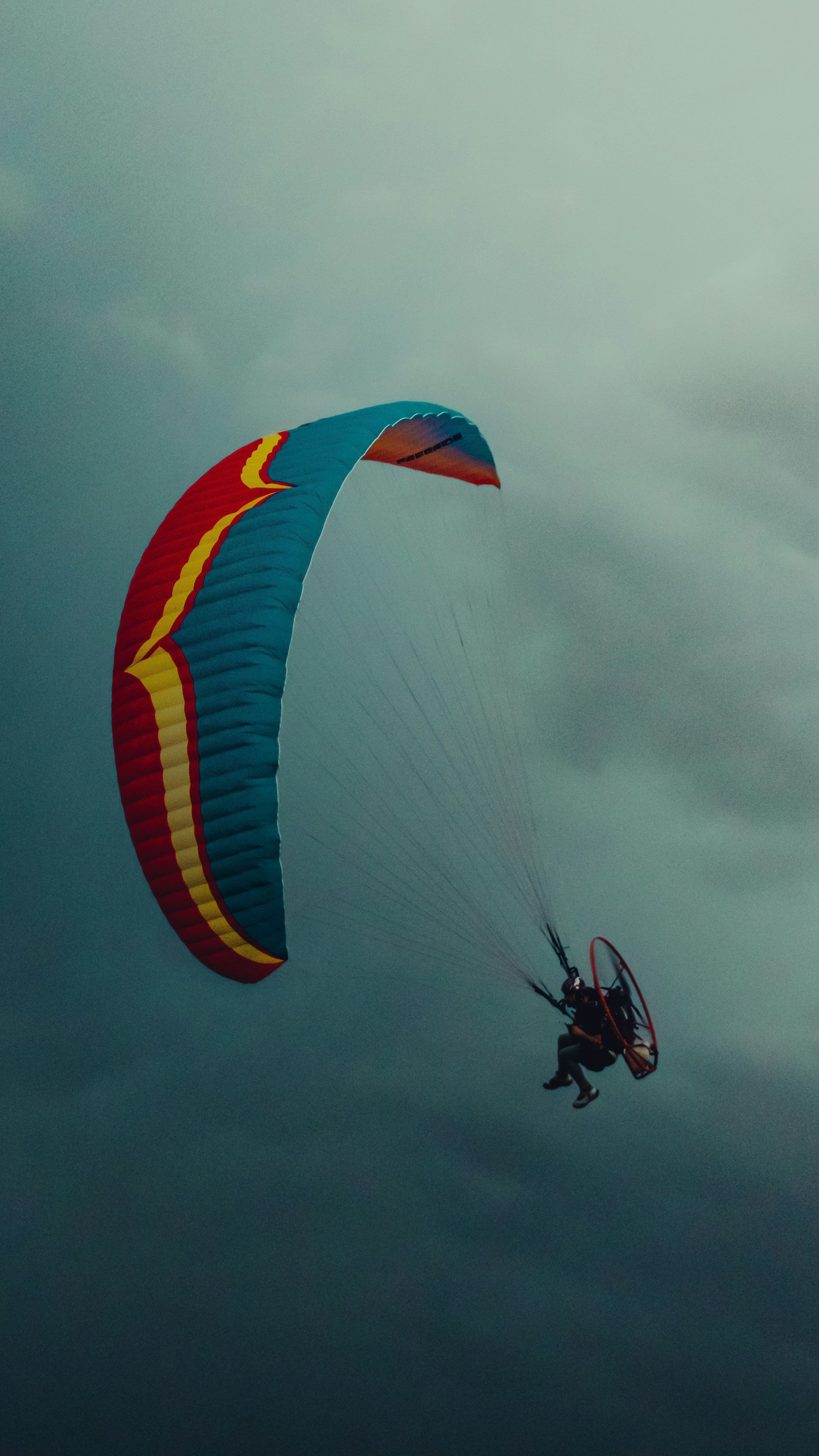 a person is parasailing on a cloudy day