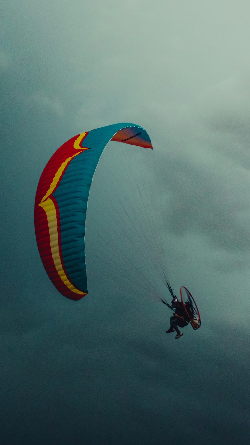 a person is parasailing on a cloudy day