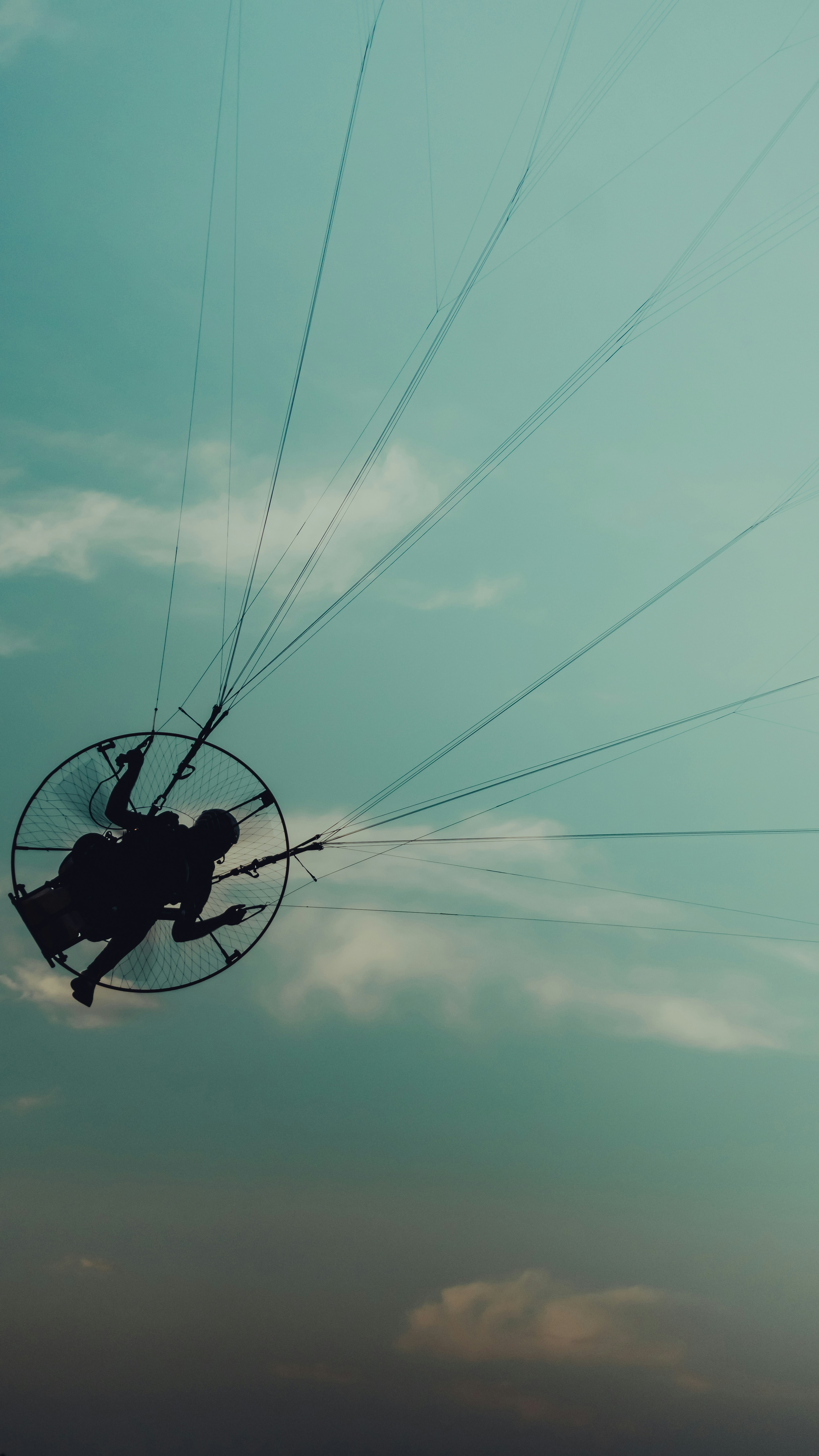 a person is flying through the air on a parachute
