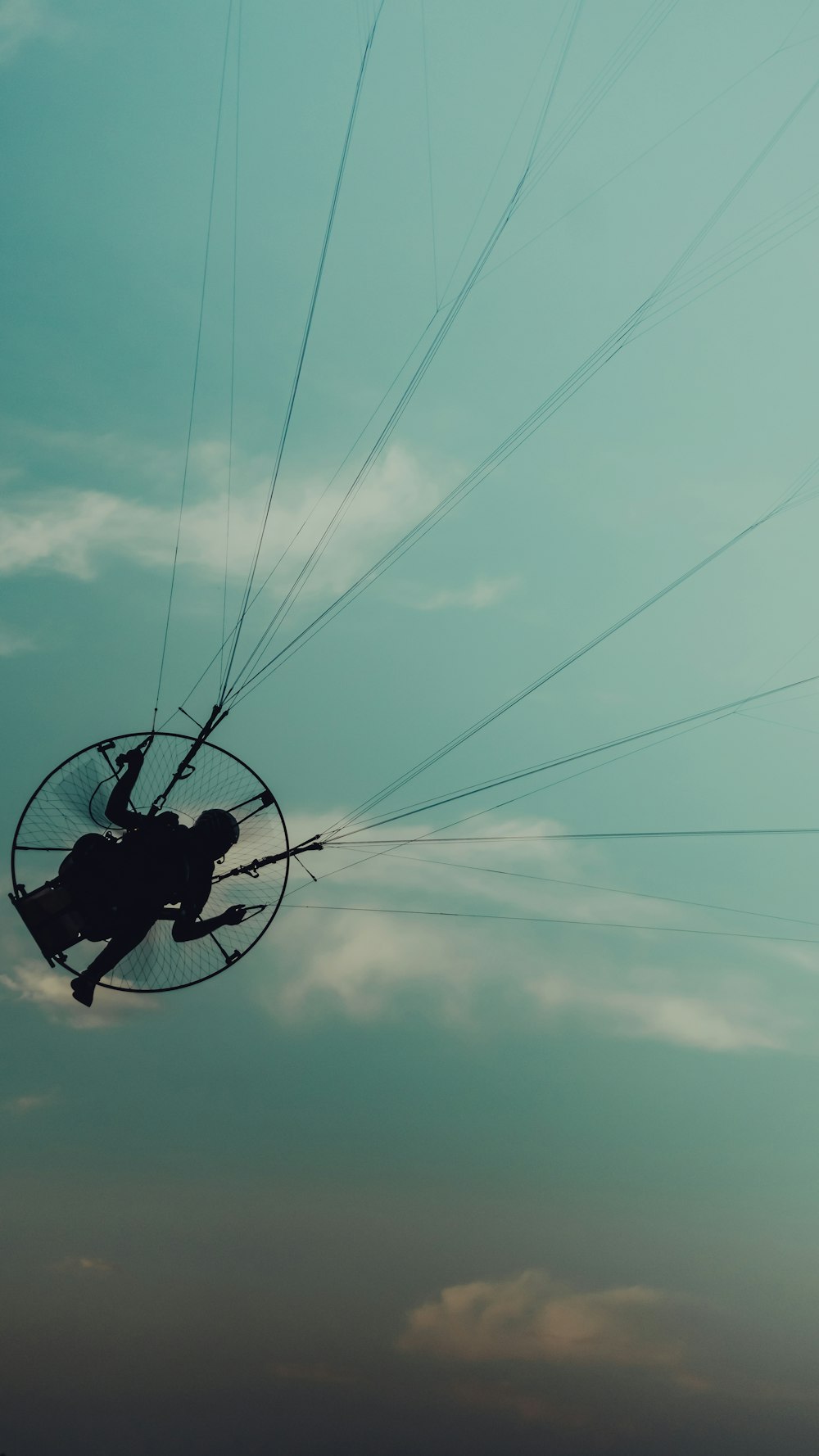 a person is flying through the air on a parachute