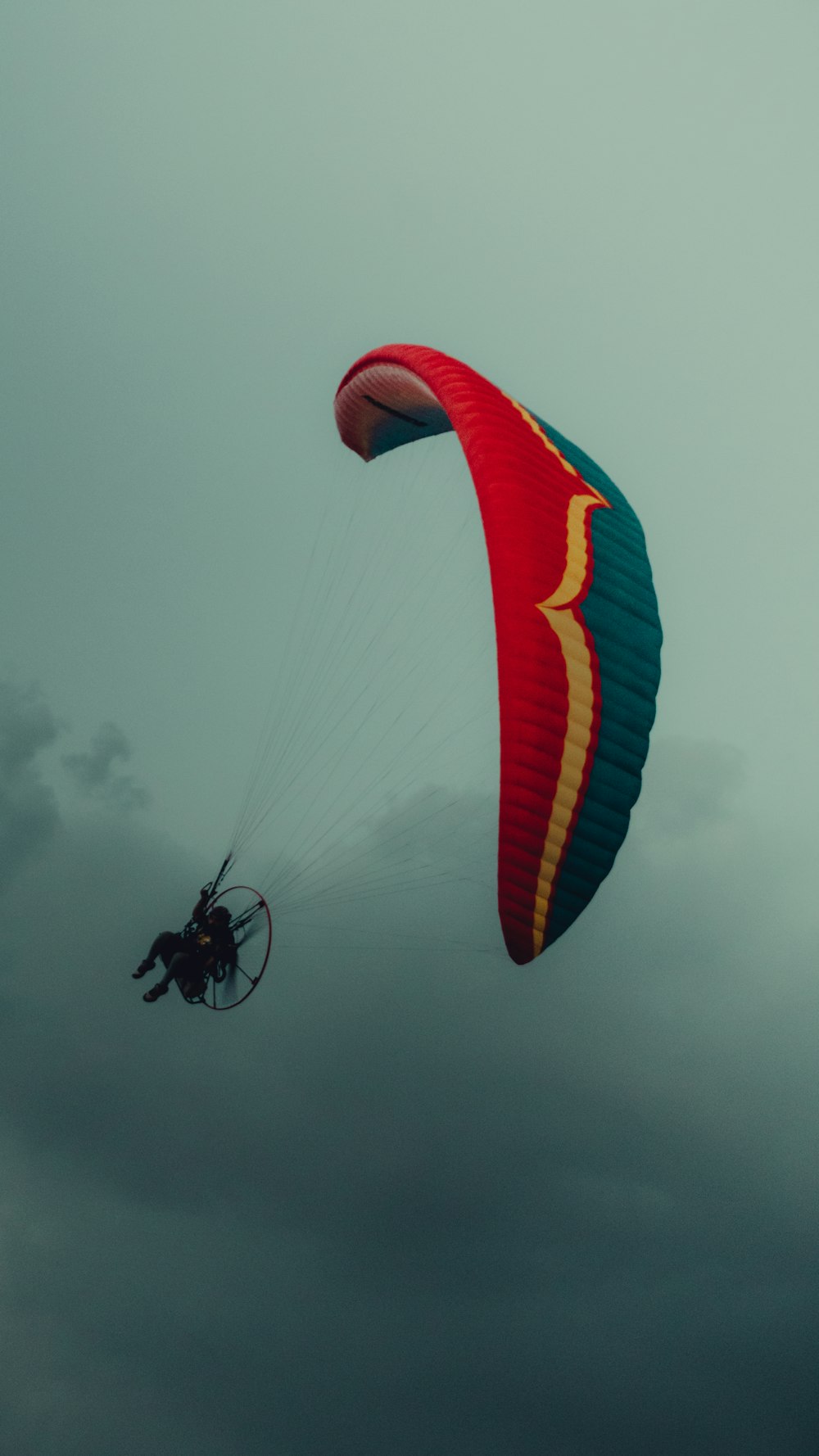 a person is parasailing on a cloudy day