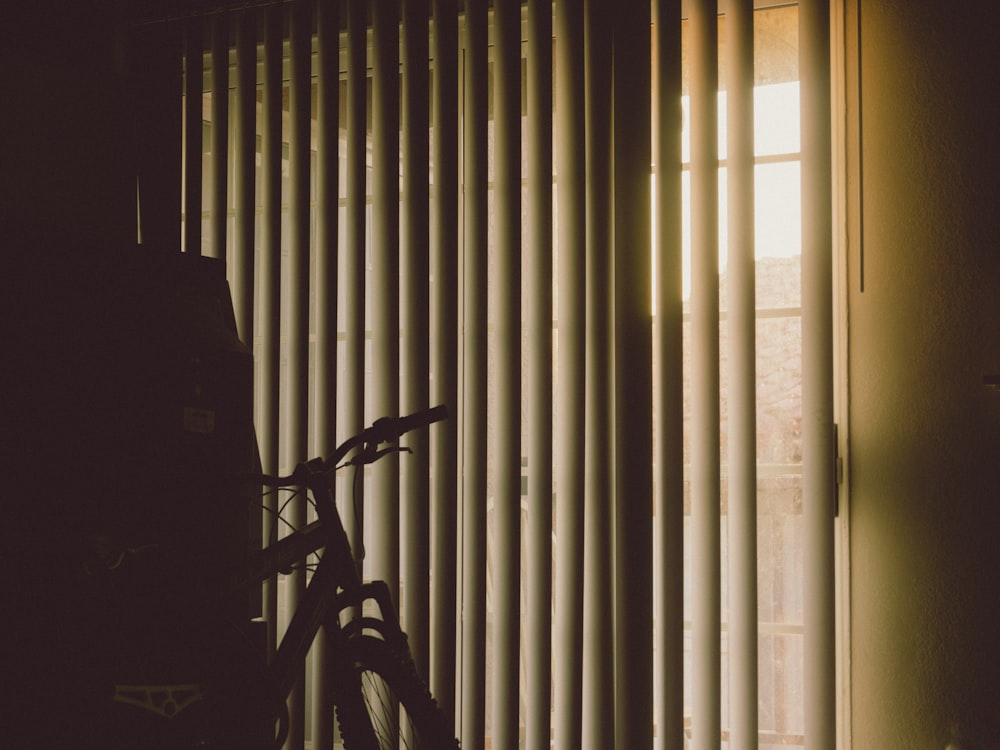 a bicycle is parked in front of a window