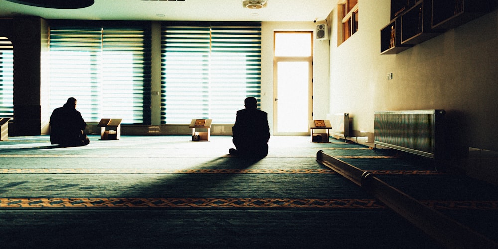 two people sitting on the floor in a room