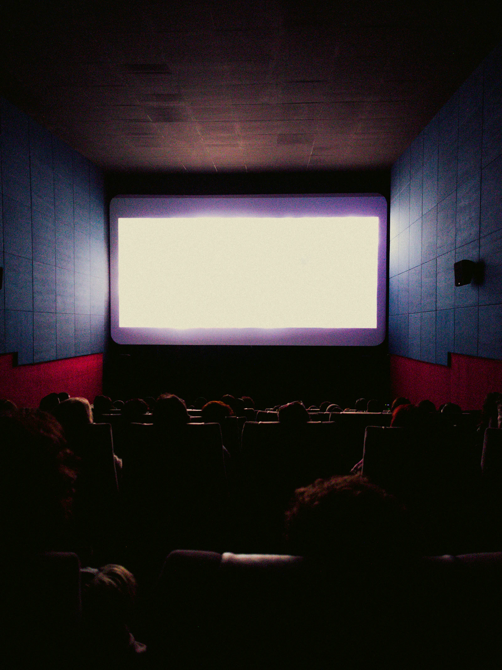 An audience watching a film on a big screen